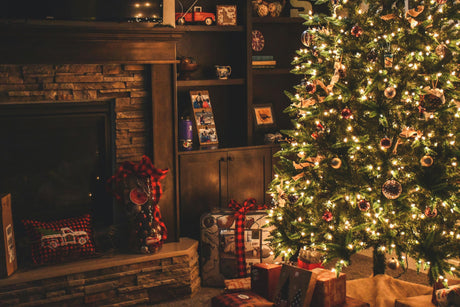 Cozy living room with decorated Christmas tree and wrapped presents.